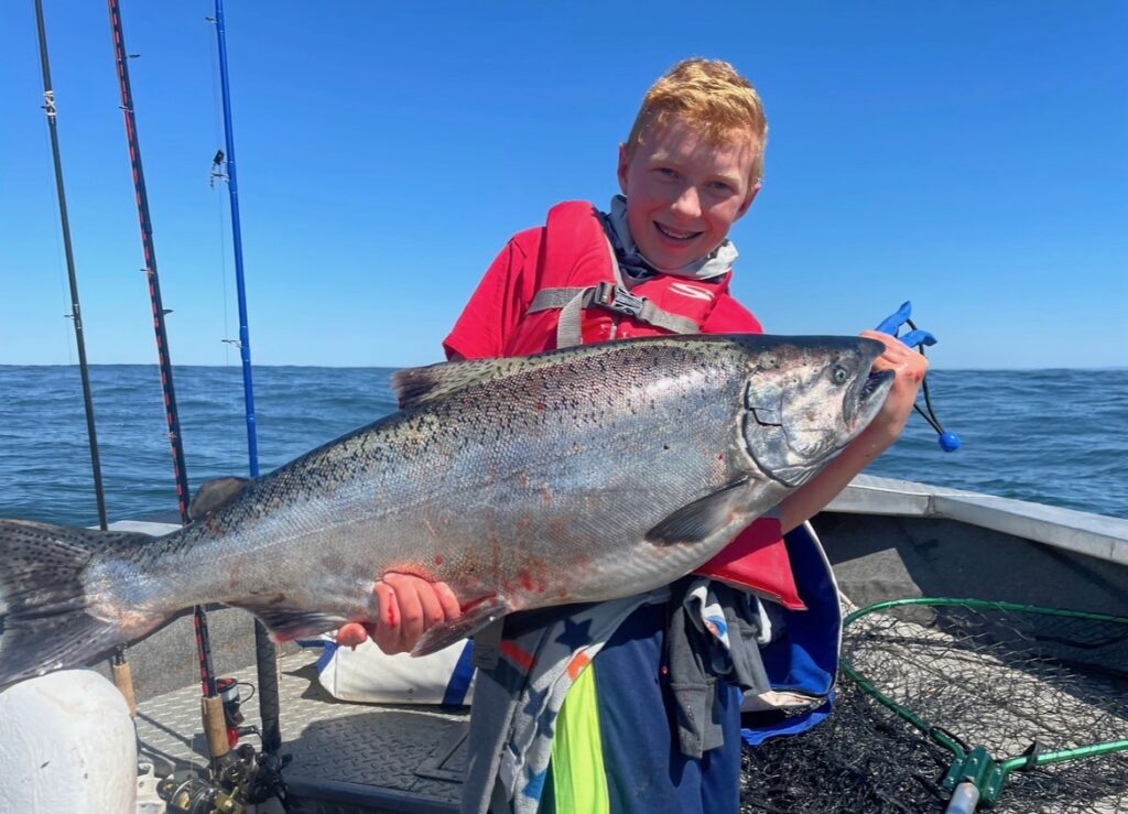 Boy holding salmon